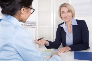 Senior business woman in interview with a trainee - application